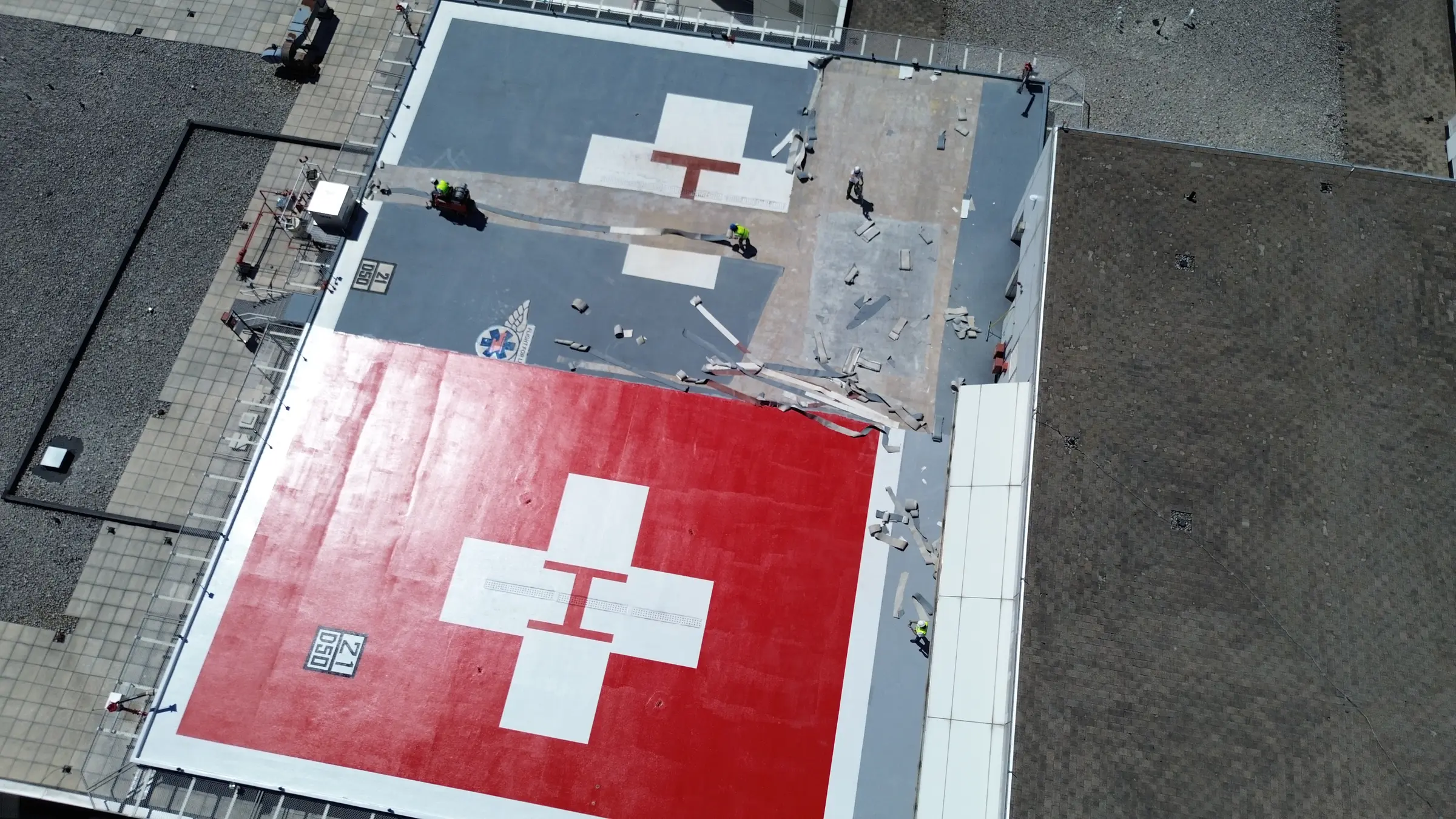 Aerial view of a rooftop helipad during surface preparation